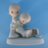 Precious Moments Figurine - Boy Helping Friend after Coaster Accident